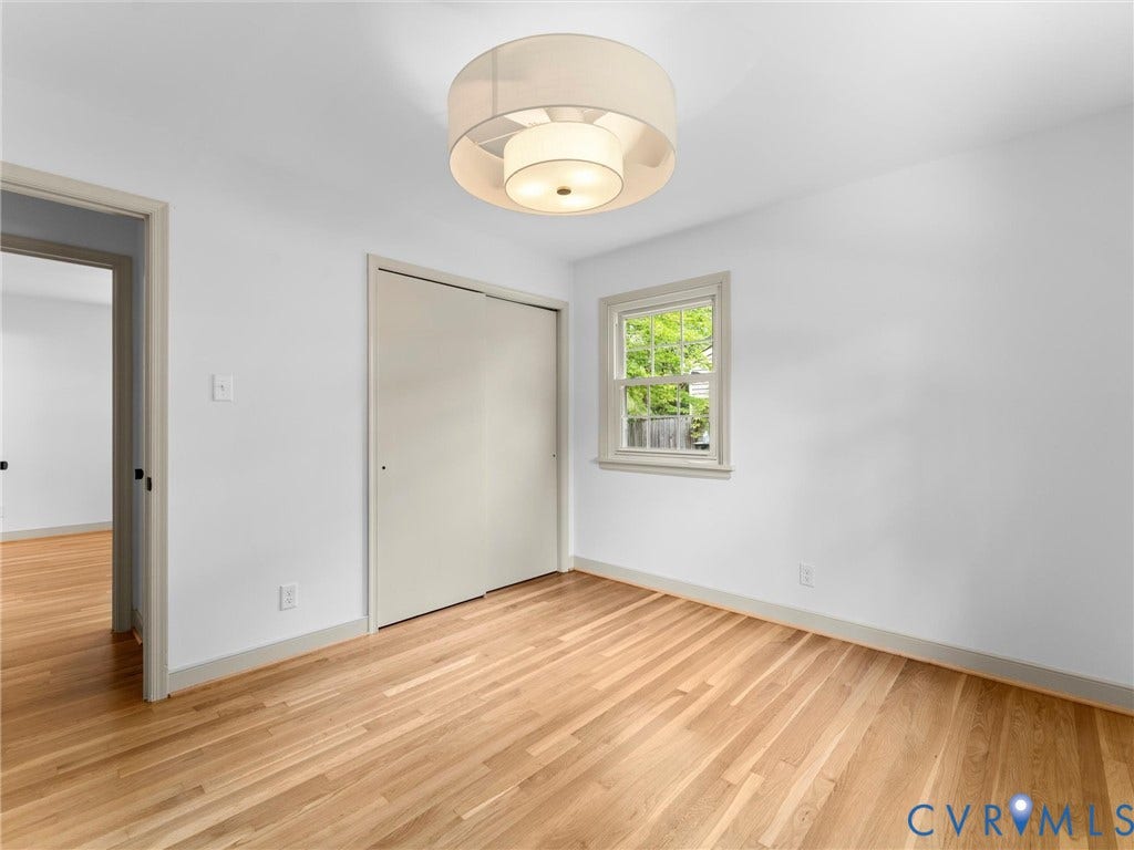 10400 Claybar Trail, Chesterfield, VA 23236 Hardwood flooring throughout, featuring a drum pendant light fixture and a double-door closet with sliding panels