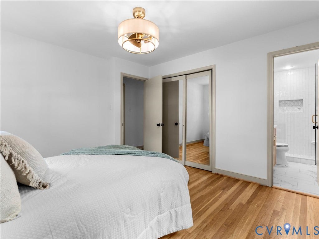 10400 Claybar Trail, Chesterfield, VA 23236 Bright bedroom with polished wood-finish flooring, a contemporary semi-flush mount light fixture, and a mirrored closet door