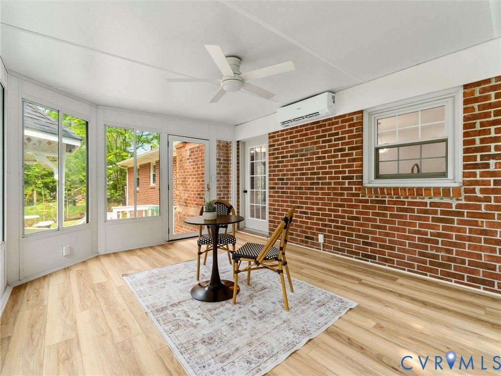 10400 Claybar Trail, Chesterfield, VA 23236 Sunroom featuring a brick wall accent, wood-finish flooring, and multiple window panels
