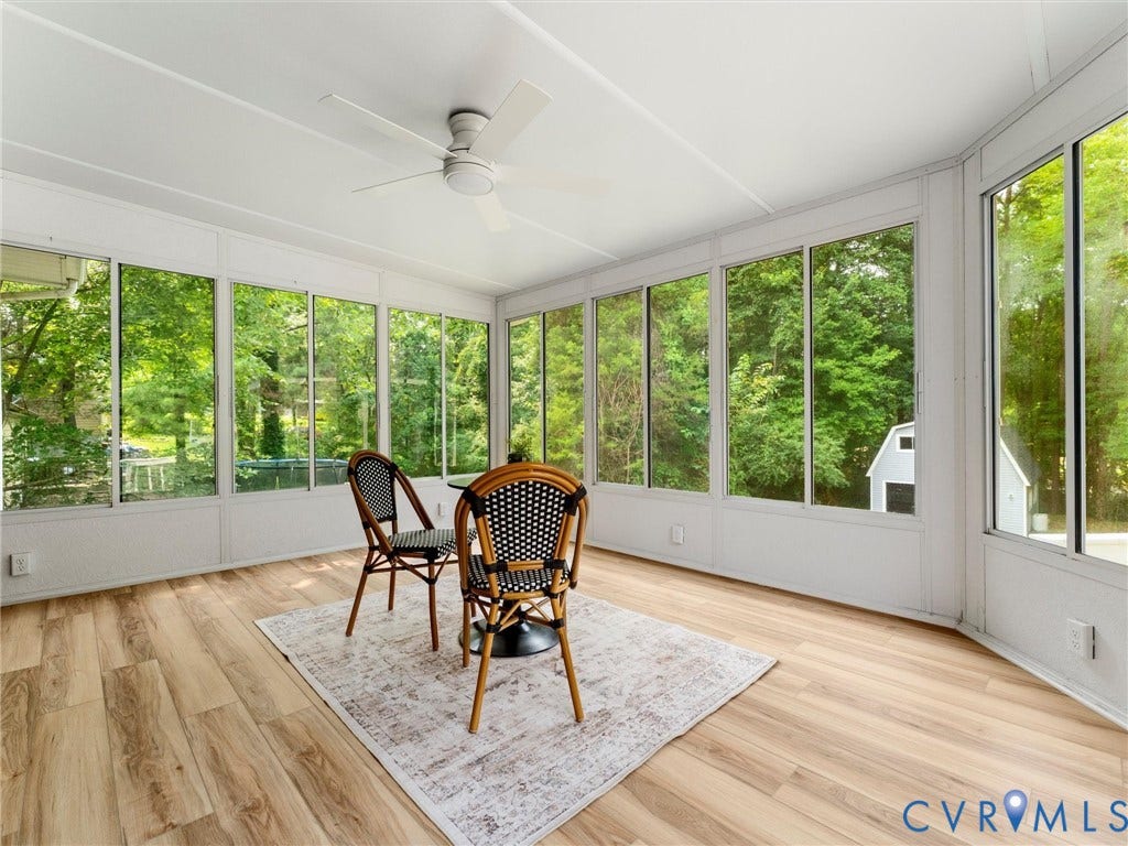 10400 Claybar Trail, Chesterfield, VA 23236 Sunroom featuring extensive window panels, wood-finish flooring, and a ceiling fan with integrated lighting