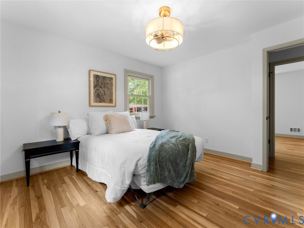 10400 Claybar Trail, Chesterfield, VA 23236 Spacious and Bright primary bedroom featuring wood-finish flooring, white walls, and a modern ceiling fan with integrated lighting