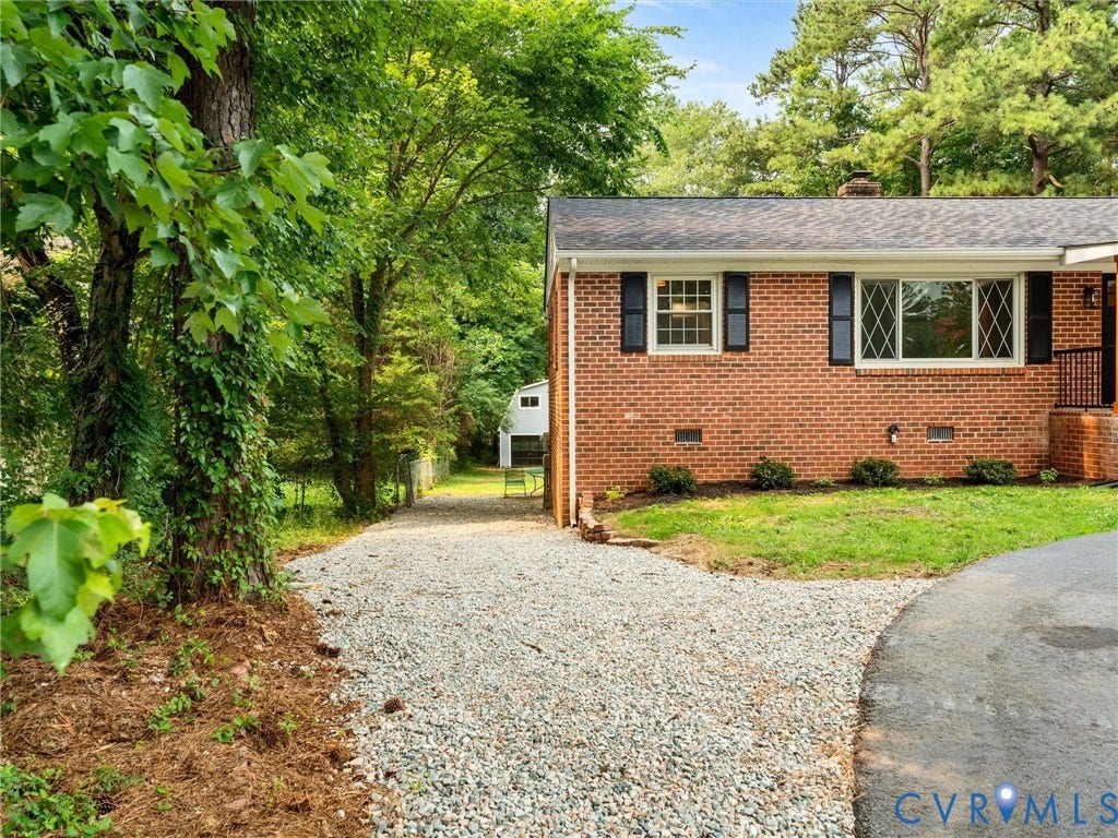10400 Claybar Trail, Chesterfield, VA 23236 Brick exterior featuring black shutters and multiple window styles including a diamond-pane window