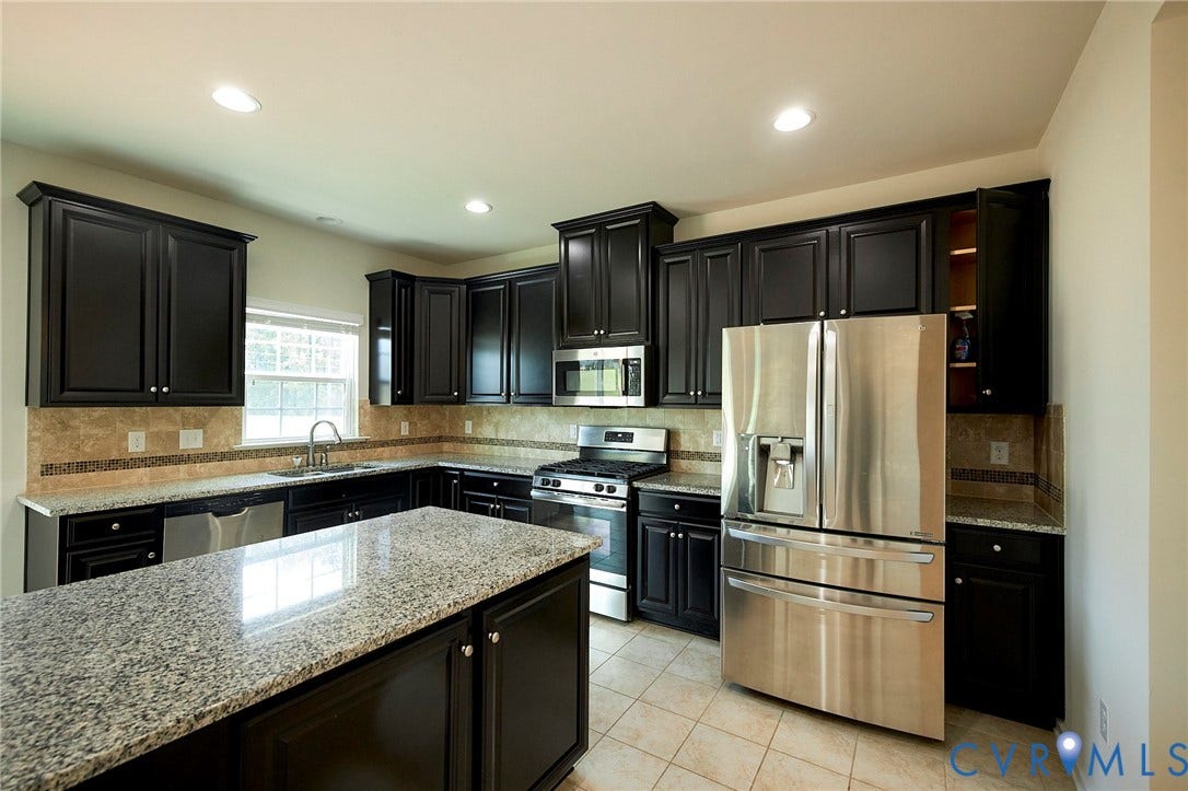 4535 Paxton Glen Court, 3W120, Glen Allen, VA 23059 Kitchen featuring dark wood cabinetry, light granite countertops, stainless steel appliances, a tiled backsplash, and recessed lighting