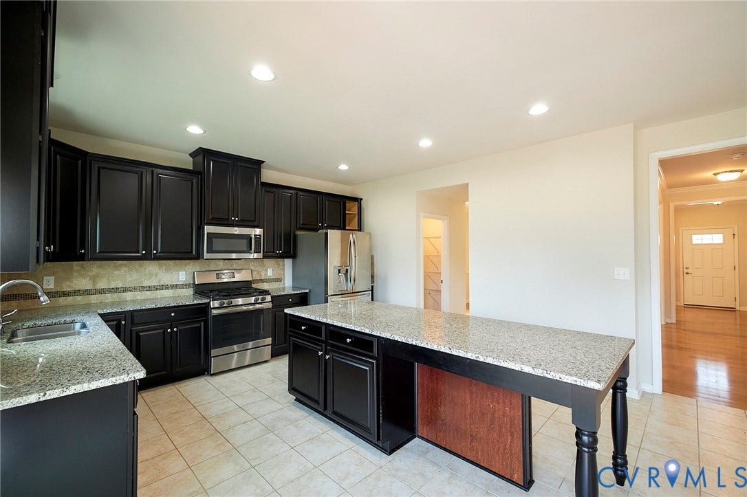 4535 Paxton Glen Court, 3W120, Glen Allen, VA 23059 Kitchen featuring dark cabinetry, light granite countertops, stainless steel appliances, a center island with granite top, and recessed lighting