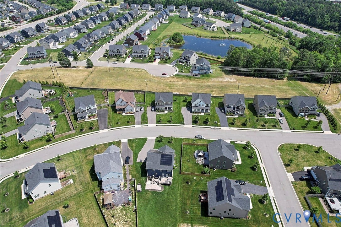4535 Paxton Glen Court, 3W120, Glen Allen, VA 23059 Aerial perspective of a developed residential community featuring numerous single-family homes with gray shingle roofs and varied exterior finishes