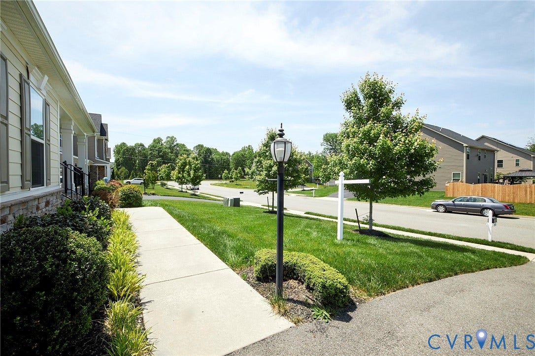 4535 Paxton Glen Court, 3W120, Glen Allen, VA 23059 Curb appeal featuring a concrete walkway, established landscaping, and a street lamp