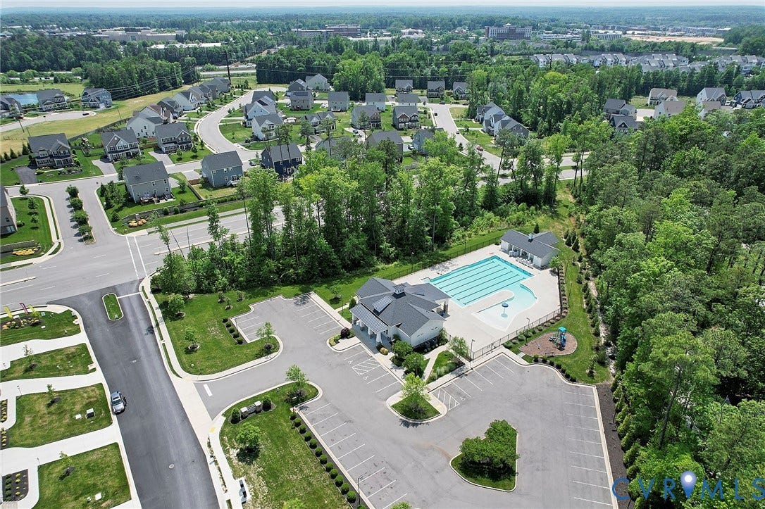 4535 Paxton Glen Court, 3W120, Glen Allen, VA 23059 Community amenities featuring a large outdoor swimming pool, adjacent building, and expansive parking area