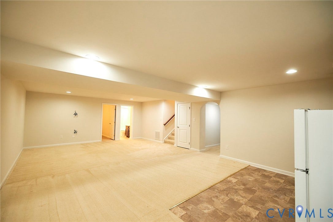 4535 Paxton Glen Court, 3W120, Glen Allen, VA 23059 Spacious finished area featuring recessed lighting, a combination of carpet and patterned tile flooring, an arched doorway, and a visible staircase