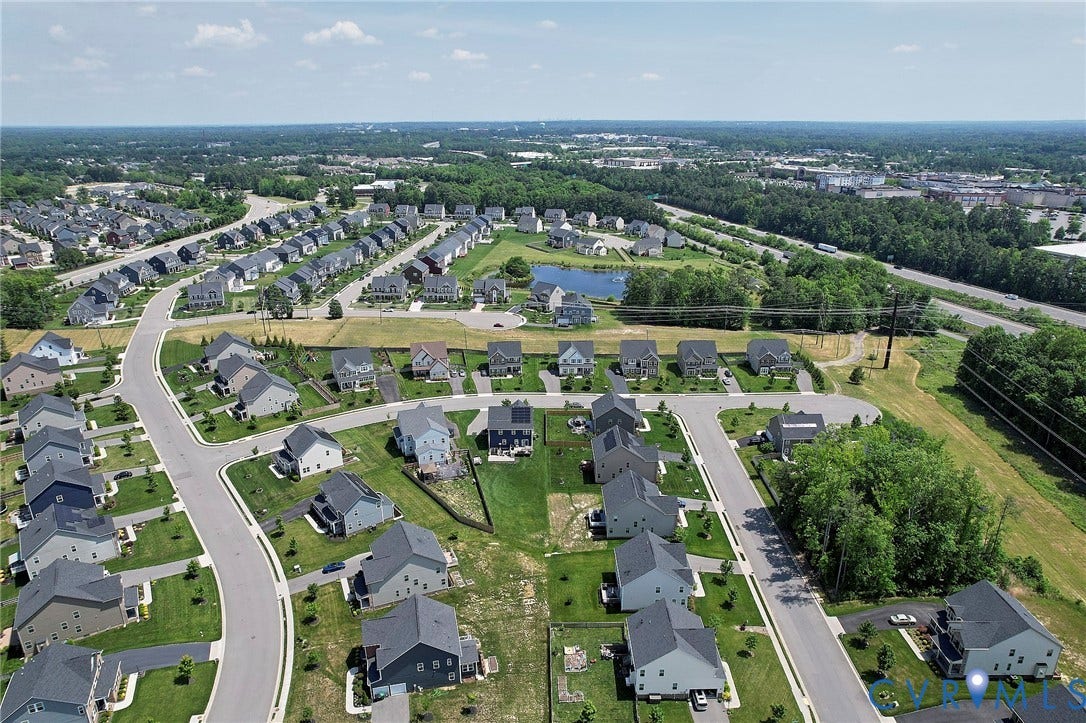 4535 Paxton Glen Court, 3W120, Glen Allen, VA 23059 Aerial view showcasing a residential community with numerous single-family homes, curved roadways, and lush green spaces