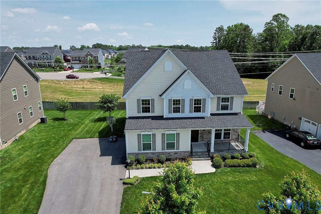 4535 Paxton Glen Court, 3W120, Glen Allen, VA 23059 Two-story residence featuring light-colored siding with stone accents, a covered front porch, and an attached two-car garage