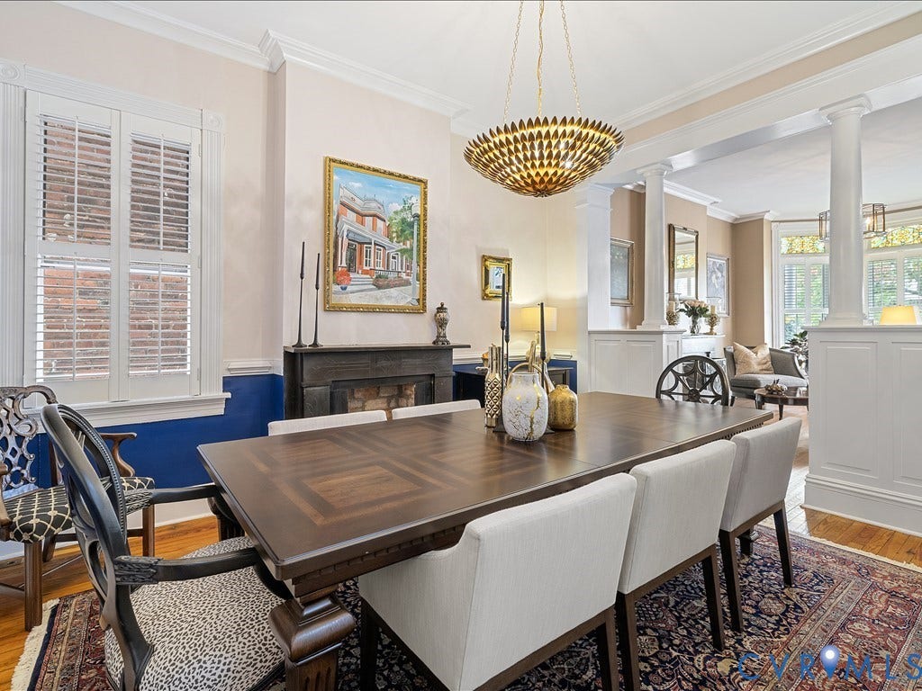 3108 E Broad Street, St John's Historic, Richmond, VA 23223 Dining area featuring rich wood-finish flooring, a decorative fireplace, and a striking chandelier