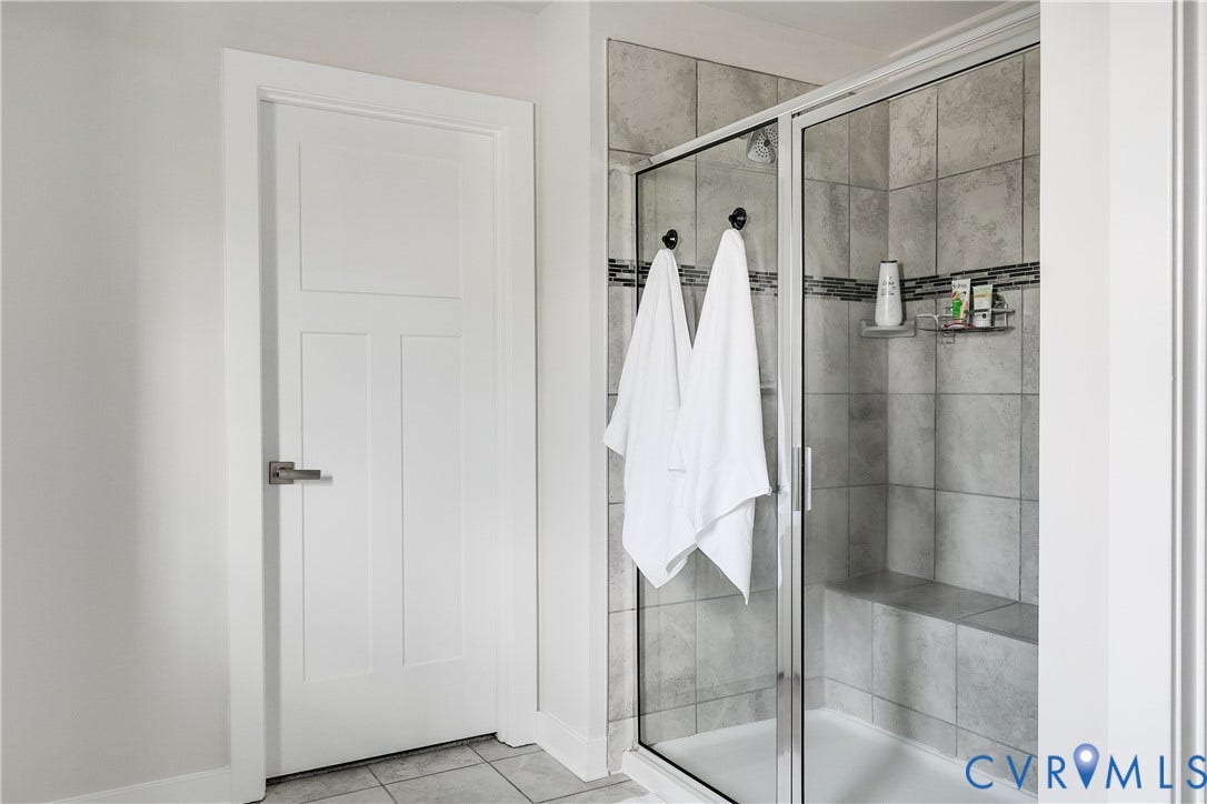 18301 Sagamore Drive, Hampton Pointe, Moseley, VA 23120 Enclosed shower with a built-in bench