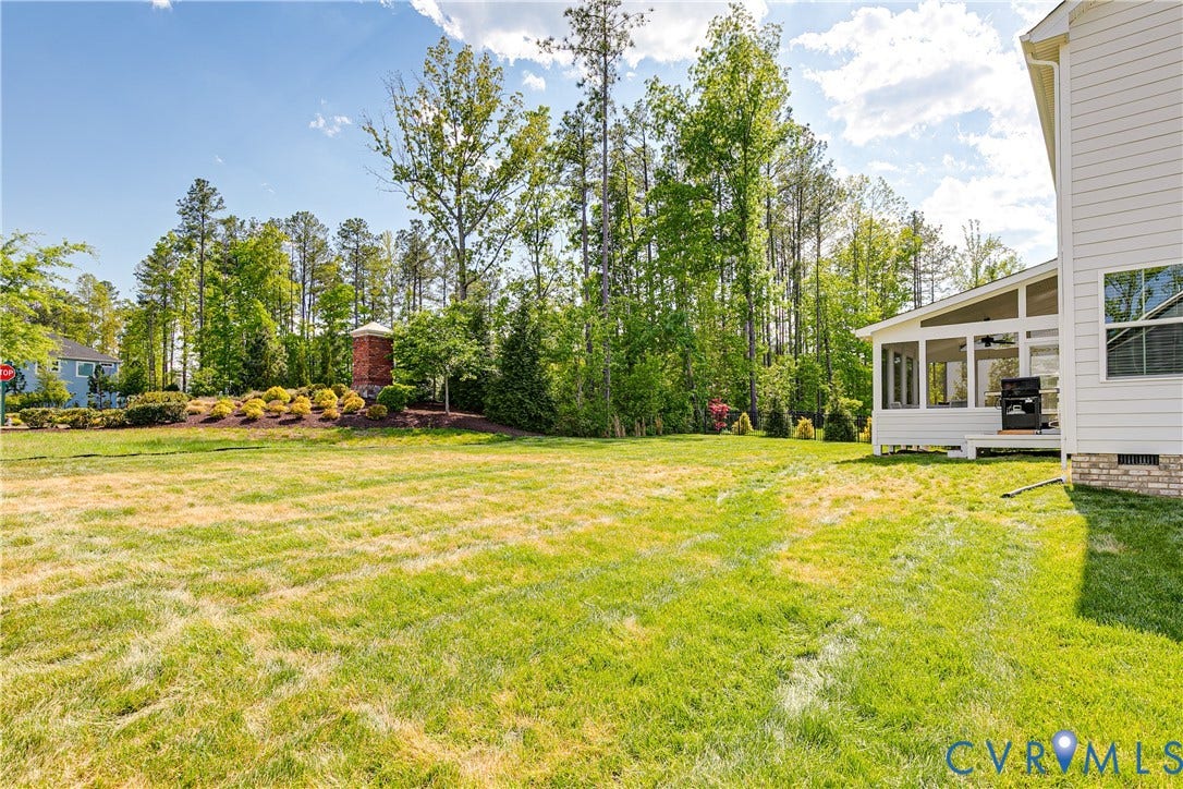 18301 Sagamore Drive, Hampton Pointe, Moseley, VA 23120 Expansive grass yard featuring a screened porch with a ceiling fan