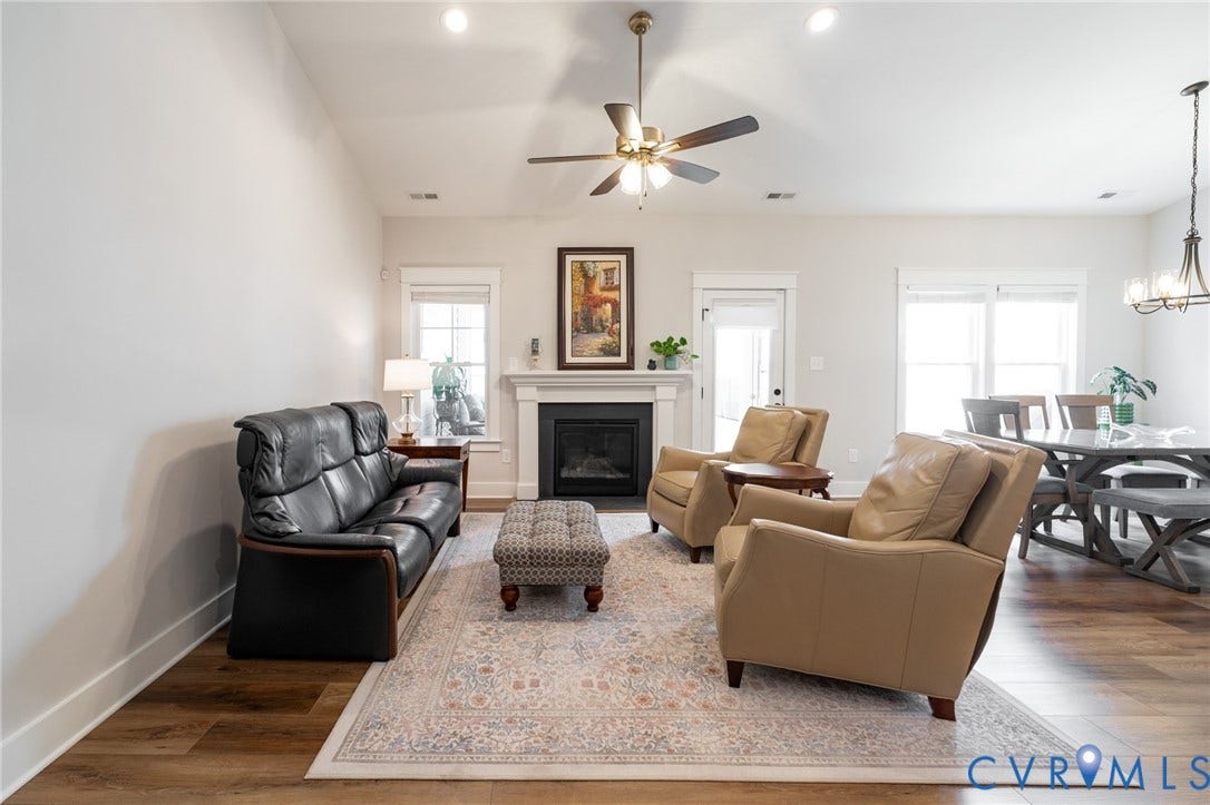 10508 Goosecross Way, Stag's Leap/ Stag's Trail, Hanover, VA 23116 Open-concept living area featuring a fireplace with a white mantel, wood-finish flooring, and recessed lighting