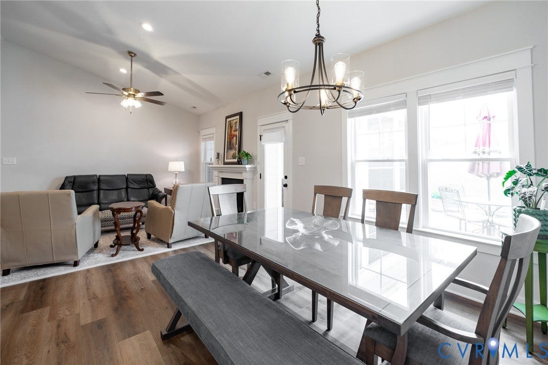 10508 Goosecross Way, Stag's Leap/ Stag's Trail, Hanover, VA 23116 Open-concept living area featuring wood-finish flooring, a vaulted ceiling, and a fireplace with a mantel
