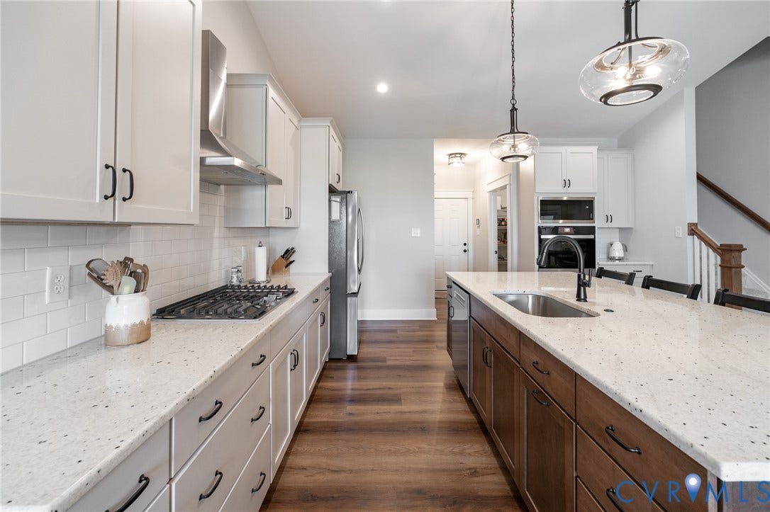 10508 Goosecross Way, Stag's Leap/ Stag's Trail, Hanover, VA 23116 Modern kitchen featuring white shaker cabinets, light speckled countertops, a built-in gas range with stainless steel hood, and wood-finish flooring
