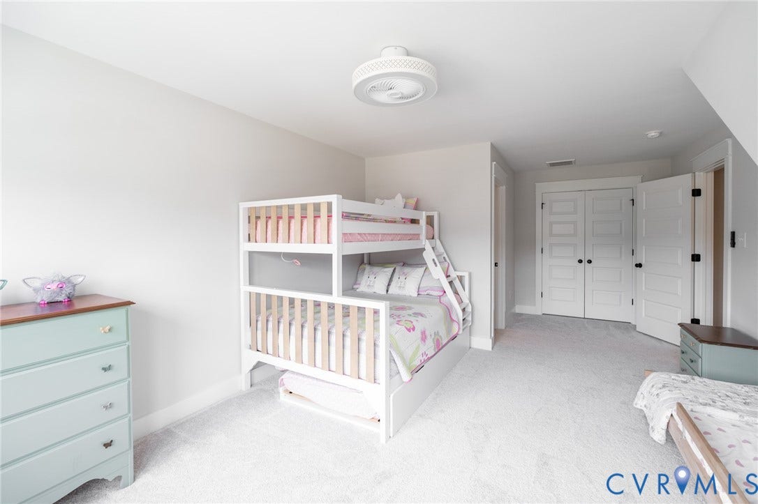 10508 Goosecross Way, Stag's Leap/ Stag's Trail, Hanover, VA 23116 Carpeted upper bedroom featuring a ceiling fan aka 'a fandelier', white walls, and a closet with double panel doors