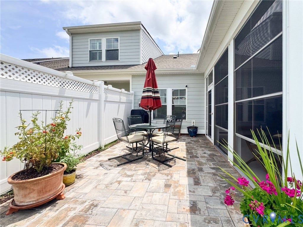 10508 Goosecross Way, Stag's Leap/ Stag's Trail, Hanover, VA 23116 Expansive paver patio with a white vinyl lattice-top privacy fence and a screened lanai entry