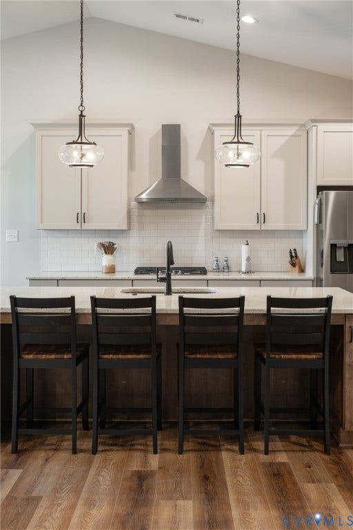 10508 Goosecross Way, Stag's Leap/ Stag's Trail, Hanover, VA 23116 Kitchen featuring a spacious island, pendant lighting, wood-finish flooring, white subway tile backsplash, and a stainless steel range hood