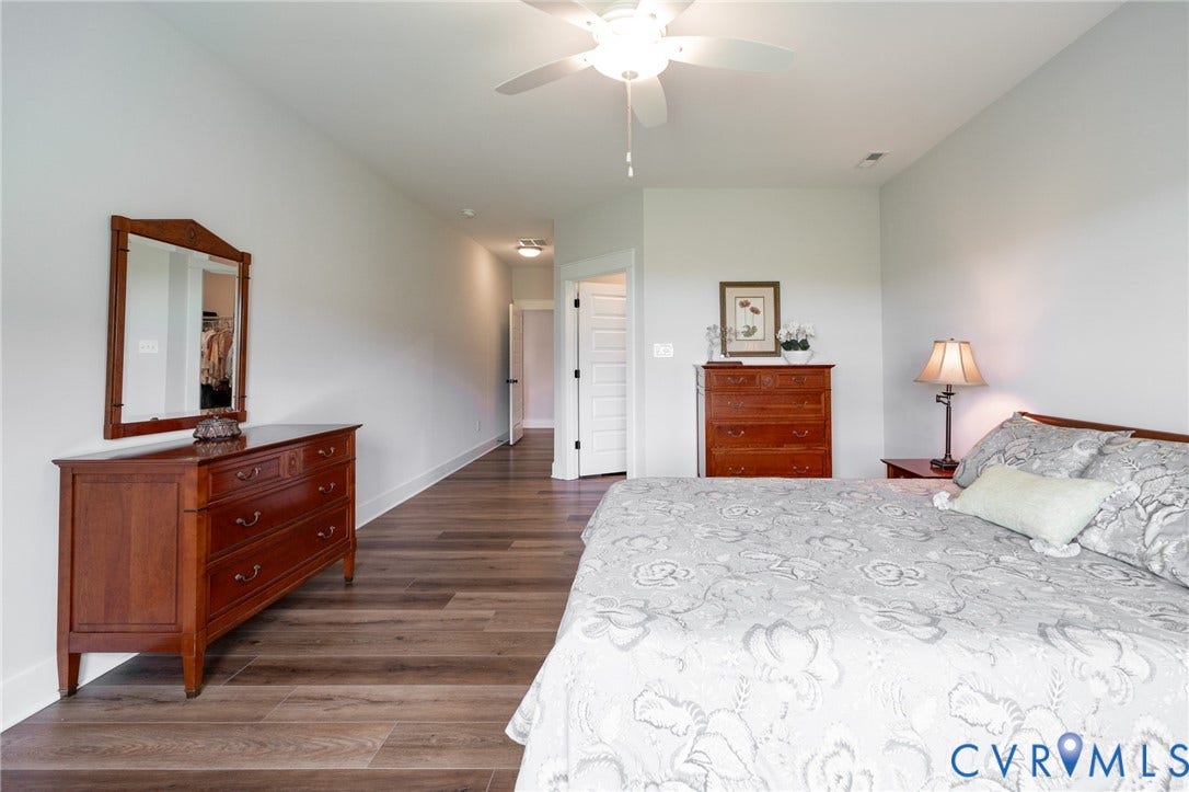 10508 Goosecross Way, Stag's Leap/ Stag's Trail, Hanover, VA 23116 Spacious room featuring wood-finish flooring, light-toned walls, and a ceiling fan with integrated lighting