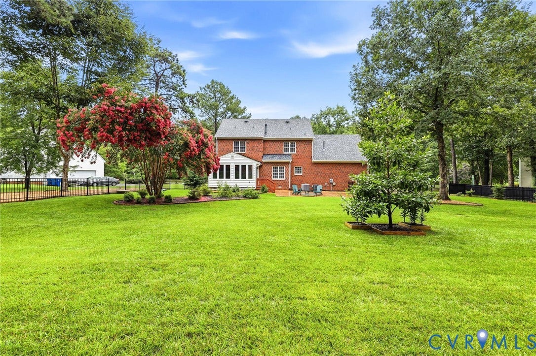 12124 Glen Kilchurn Drive, Chesterfield, VA 23838 Expansive green lawn with mature trees and a vibrant flowering shrub