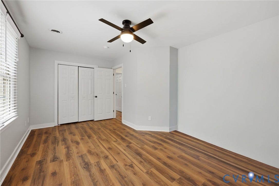 12124 Glen Kilchurn Drive, Chesterfield, VA 23838 Spacious room featuring wood-finish flooring, light grey walls, white trim, and a contemporary ceiling fan with integrated lighting