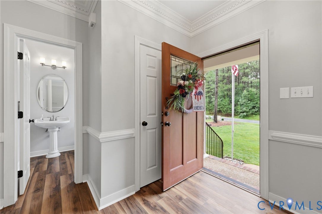 12124 Glen Kilchurn Drive, Chesterfield, VA 23838 Open entryway with wood-finish flooring, crown molding, and light gray wall paint