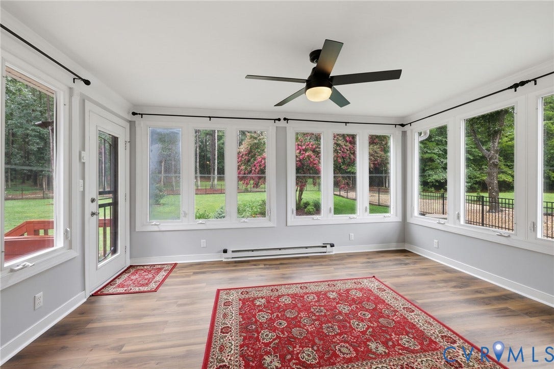12124 Glen Kilchurn Drive, Chesterfield, VA 23838 Sunroom featuring wood-finish flooring, numerous windows with white trim, a ceiling fan with integrated lighting, and a white exterior door with a screen insert