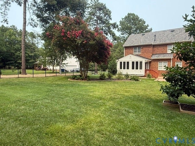 12124 Glen Kilchurn Drive, Chesterfield, VA 23838 Expansive green lawn with mature trees and a black metal fence