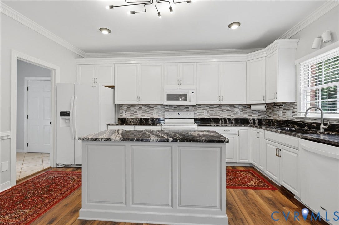 12124 Glen Kilchurn Drive, Chesterfield, VA 23838 Kitchen featuring a central island with a dark stone countertop, white cabinetry, a mosaic tile backsplash, and wood-finish flooring