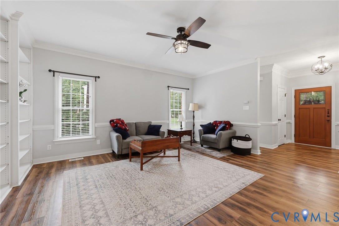 12124 Glen Kilchurn Drive, Chesterfield, VA 23838 Living area featuring wood-finish flooring, built-in shelving, a ceiling fan with integrated lighting, and a paneled front door with upper glass inserts