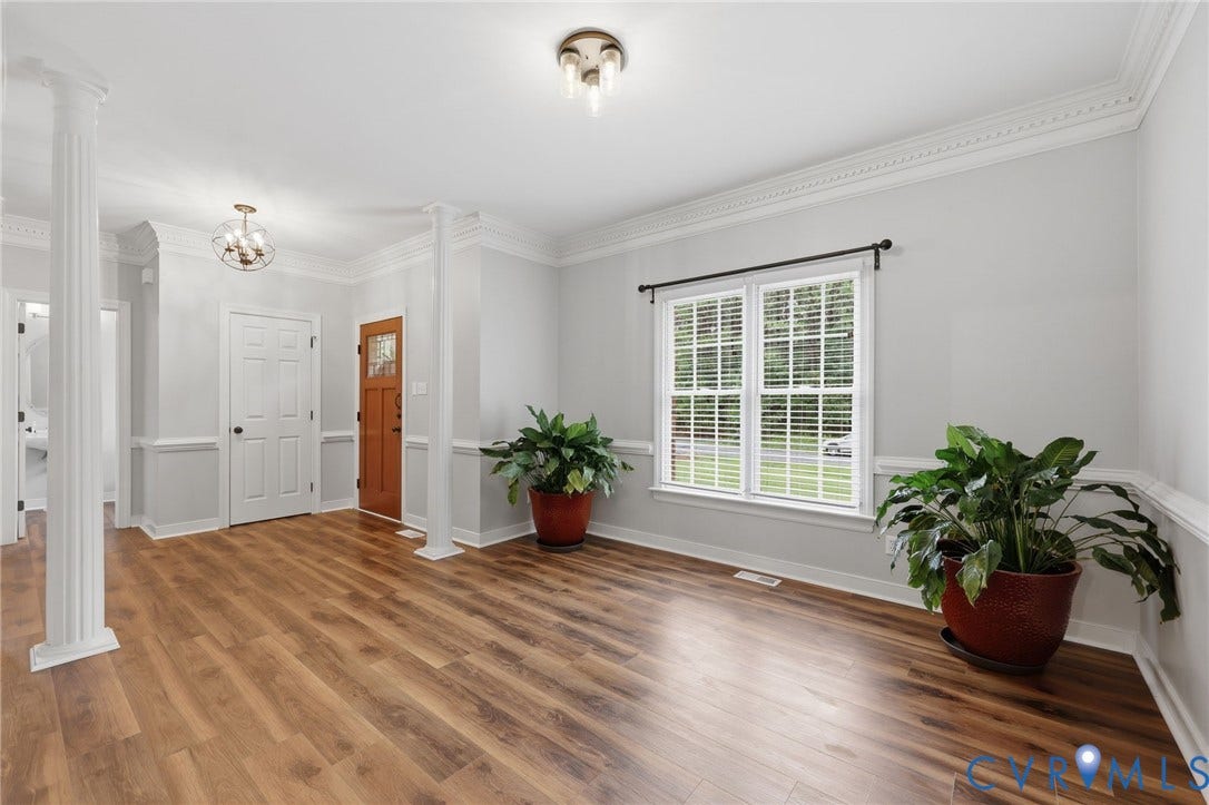 12124 Glen Kilchurn Drive, Chesterfield, VA 23838 Spacious interior featuring wood-finish flooring, white trim, and a prominent window