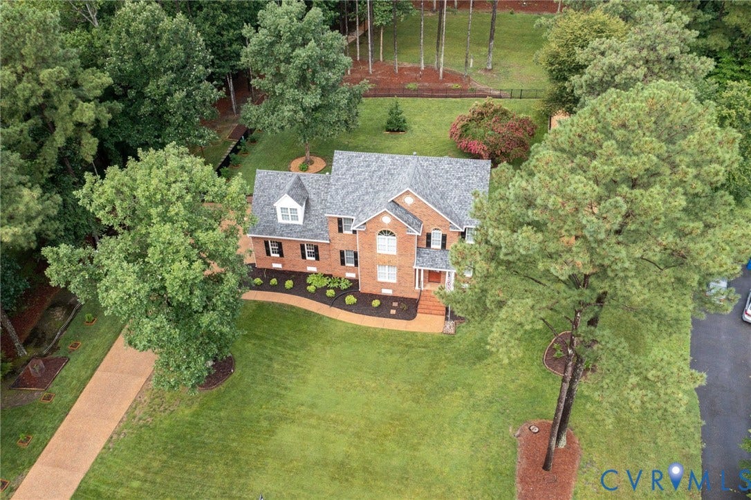 12124 Glen Kilchurn Drive, Chesterfield, VA 23838 Two-story brick exterior featuring a multi-gable roofline, dormer window, and mature landscaping
