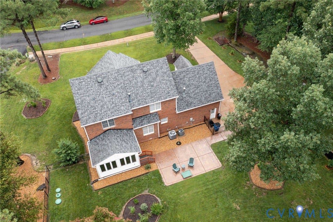 12124 Glen Kilchurn Drive, Chesterfield, VA 23838 Brick two-story residence with a gray shingle roof, featuring an attached sunroom with white trim
