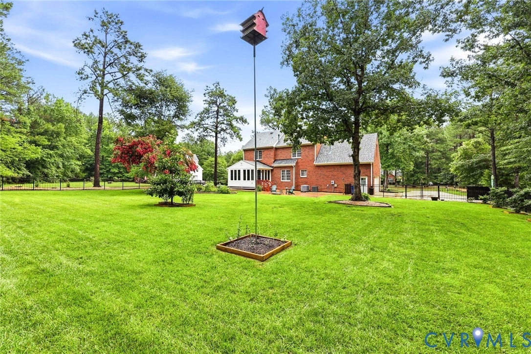 12124 Glen Kilchurn Drive, Chesterfield, VA 23838 Expansive green lawn with mature trees and a fenced perimeter
