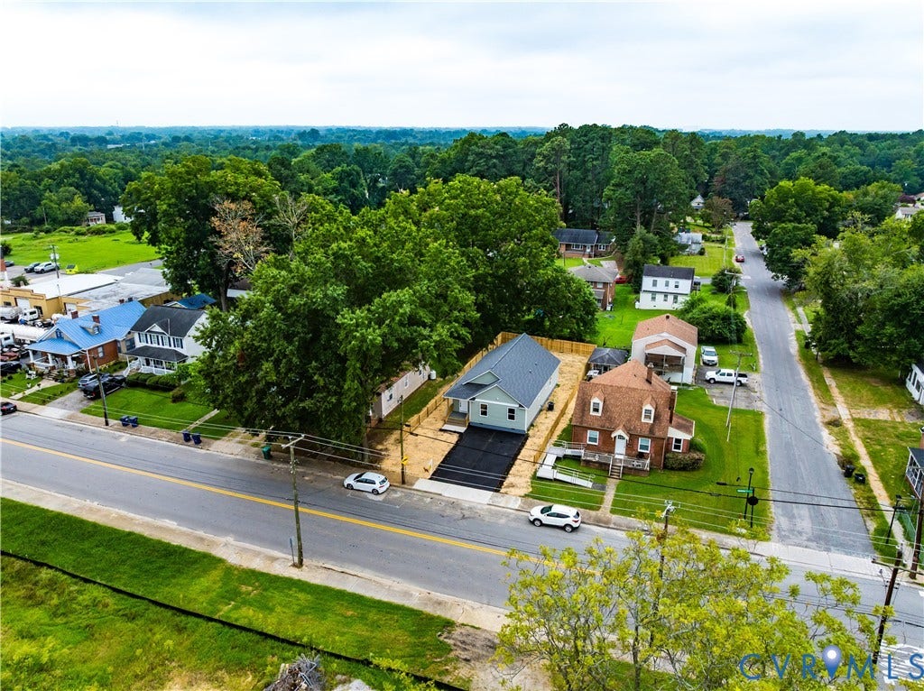 Brick Colonial residence situated on a corner lot with mature landscaping and established trees