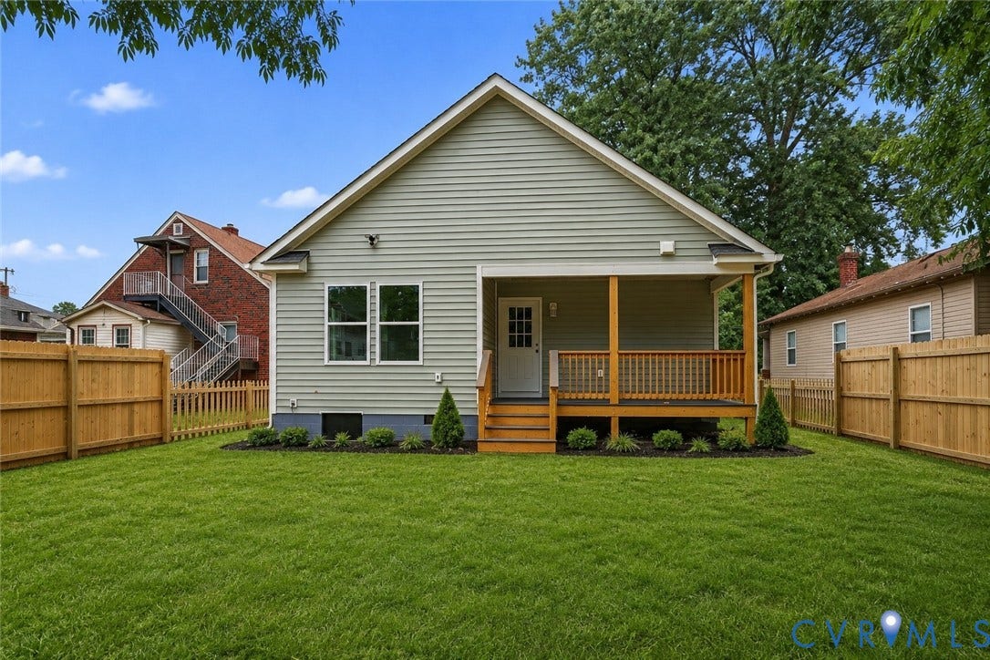 Expansive green lawn featuring a newly installed privacy fence