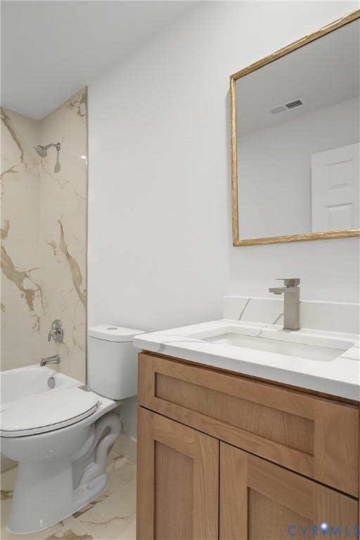 Bathroom vanity featuring light wood-finish cabinetry with a white countertop and integrated sink