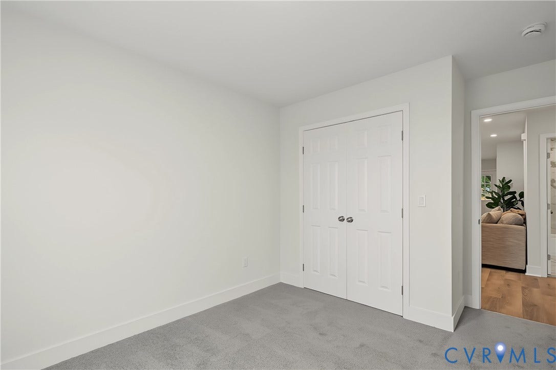 Room featuring light gray carpet flooring and white painted walls