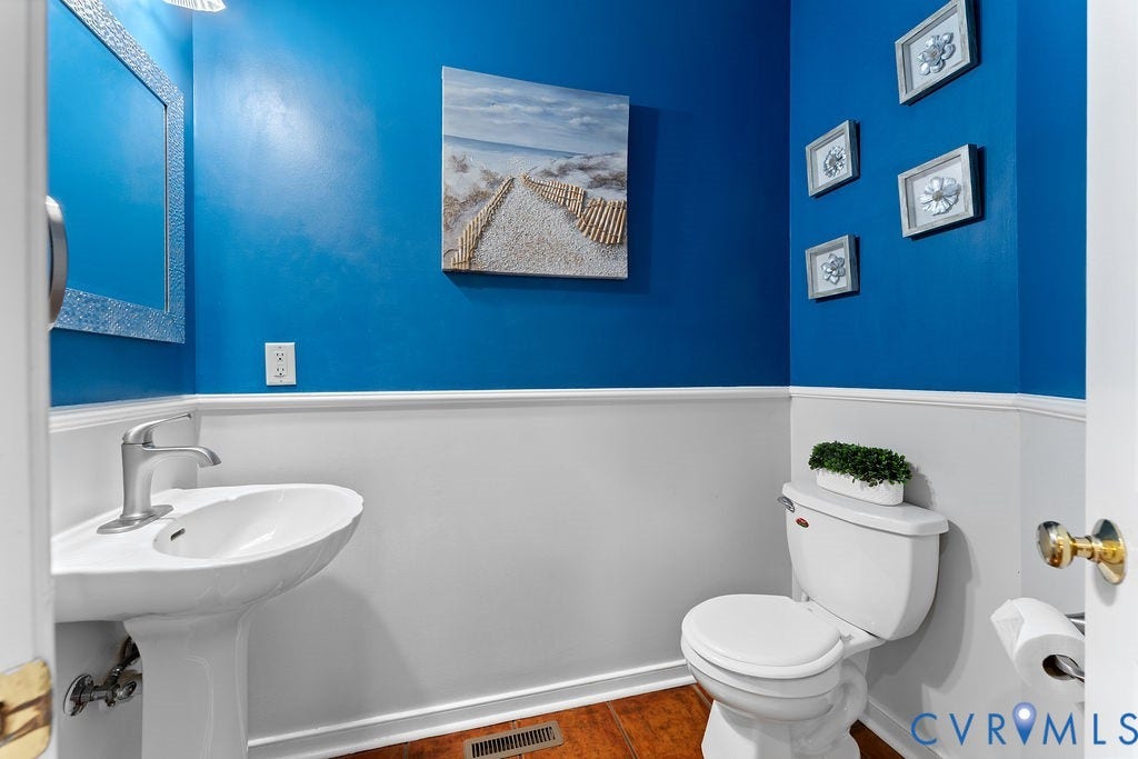 5316 Lemoore Drive, Glen Allen, VA 23059 Pedestal sink with brushed metal faucet, white wainscoting, and wood-finish flooring