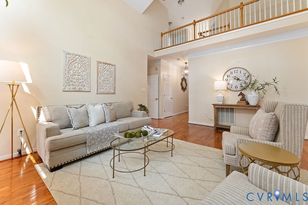 5316 Lemoore Drive, Glen Allen, VA 23059 Living space featuring a vaulted ceiling with a second-story balcony overlook, hardwood flooring, and neutral wall tones