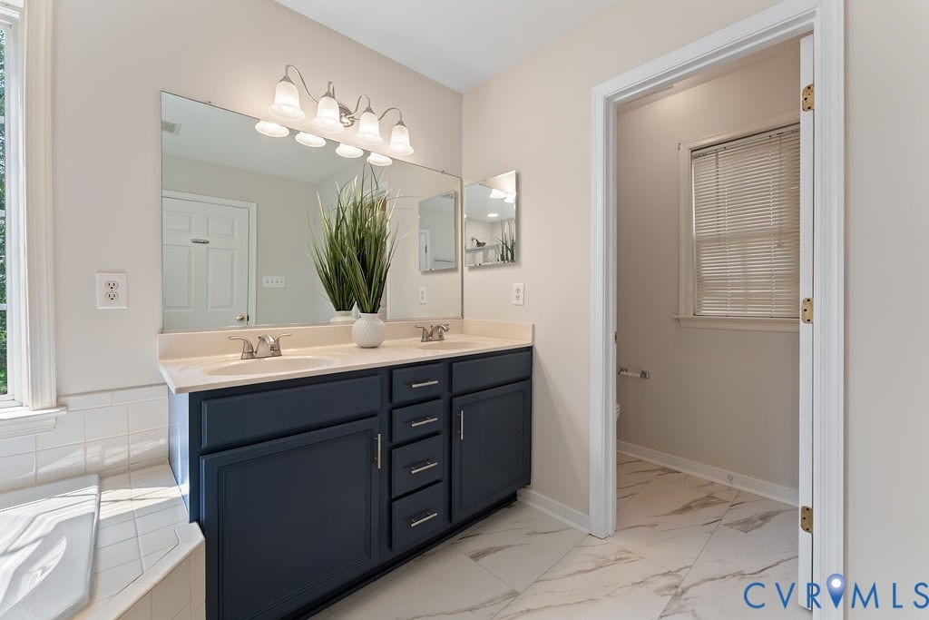 5316 Lemoore Drive, Glen Allen, VA 23059 Dual vanity with a light-toned countertop, under-mount sinks, and brushed nickel fixtures