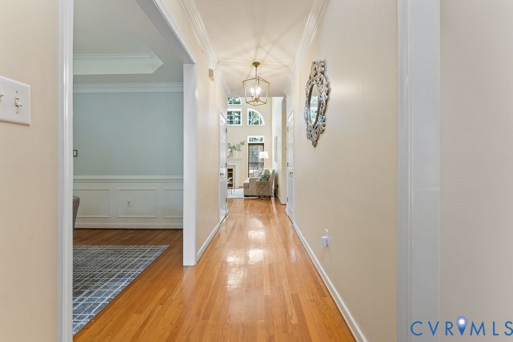 5316 Lemoore Drive, Glen Allen, VA 23059 Hardwood flooring extending through a light-filled hallway