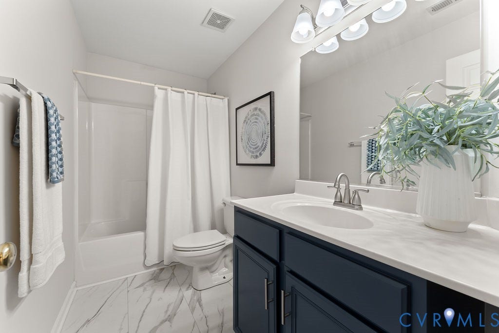 5316 Lemoore Drive, Glen Allen, VA 23059 Bathroom featuring a single vanity with a white countertop and dark blue cabinetry, a white toilet, and a white tub/shower combination