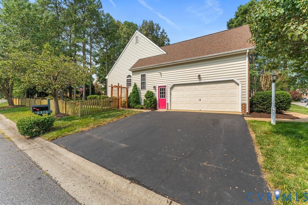5316 Lemoore Drive, Glen Allen, VA 23059 Exterior featuring light-toned siding, a two-car garage, and a vibrant red entry door