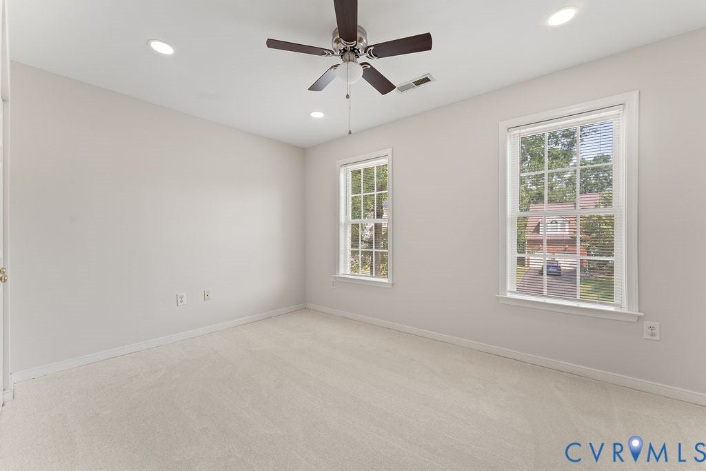 5316 Lemoore Drive, Glen Allen, VA 23059 Neutral-toned room featuring two sash windows, recessed lighting, and a ceiling fan with integrated light