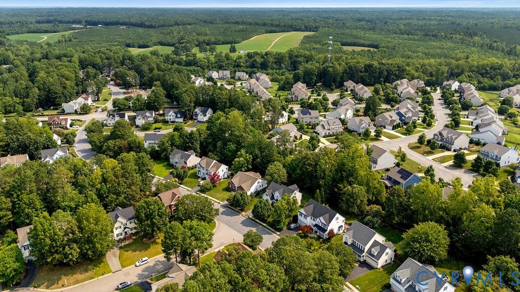 5316 Lemoore Drive, Glen Allen, VA 23059 Expansive suburban neighborhood featuring numerous homes with varied architectural styles, mature tree coverage, paved streets, and a backdrop of cultivated fields and dense woodland