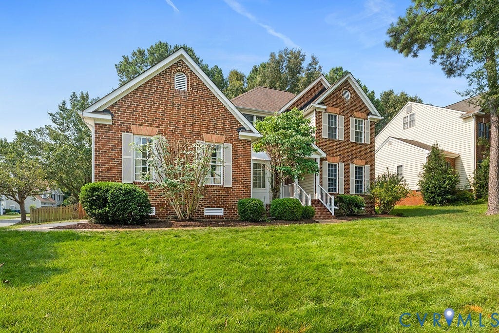 5316 Lemoore Drive, Glen Allen, VA 23059 Brick facade residence featuring multiple gables and white window shutters
