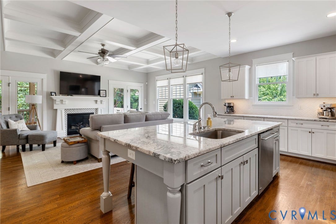 15918 Drumone Road, Hallsley, Midlothian, VA 23112 Open-concept kitchen and living area featuring a large center island with integrated sink, stainless steel appliances, and white shaker cabinetry