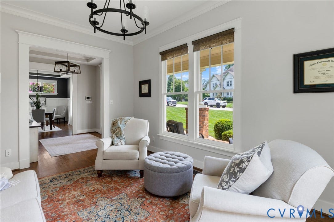 15918 Drumone Road, Hallsley, Midlothian, VA 23112 Bright room with hardwood-finish flooring, featuring a large window with natural light, a wide doorway opening, a chandelier, and crown molding